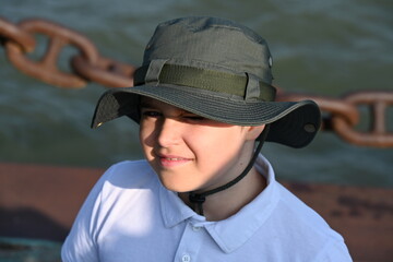 teenager in hat and white t-shirt,