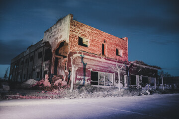 Night photography of a ruined building, destroyed, demolished by catastrophe.