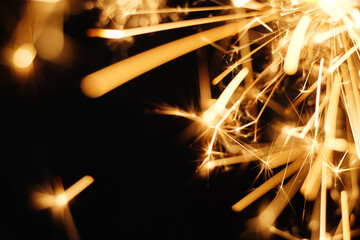 Golden spark of burning handheld firework