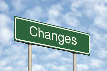 Changes ahead concept green destination signboard road sign white text frame and arrows grey pole posts large horizontal signpost perspective closeup sunny sky cloudscape motivational roadside signage