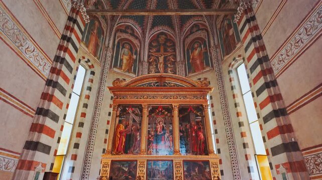 Interior of Basilica di San Zeno Maggiore displays its expansive nave flanked by pilasters and lined with historic fresco fragments, Verona, Veneto, Italy