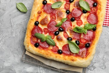 Tasty homemade pizza on grey table, top view