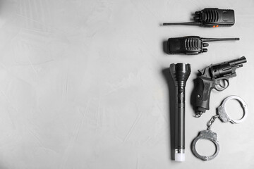 Different police equipment on light grey table, flat lay. Space for text