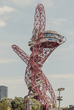 London,UK-Jun 21,2025-A stunning sculpture of ArcelorMittal Orbit and features Red lattice structure with a Spiral slide, known as the Helix, Observation tower located in Queen Elizabeth Olympic Park.