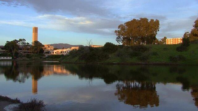 The bell tower chimes out and reflects the late afternoon light onto the lagoon at the UCSB campus near Santa Barbara, California.