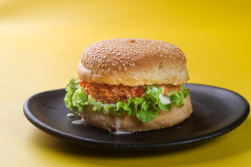chicken crispy burger on yellow background
