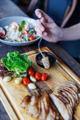 Grilled Pork Belly Perfection with Fresh Herbs and Garlic on a Rustic Wooden Board