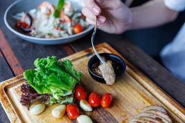 Grilled Pork Belly Perfection with Fresh Herbs and Garlic on a Rustic Wooden Board