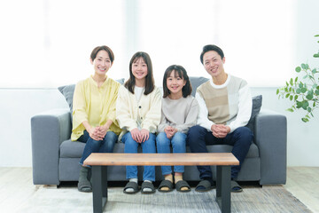 Fototapeta premium リビングのソファでリラックスする家族