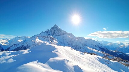 Obraz premium Majestic snow capped mountain peak reaching up towards the bright blue sky surrounded by a pristine winter landscape of glistening snow and ice This breathtaking