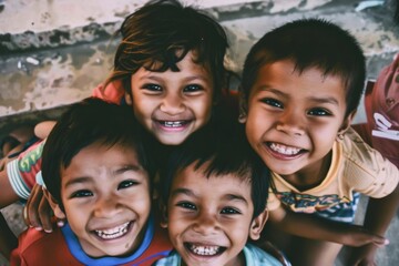 Group of kids smiling and looking at the camera in a low angle view