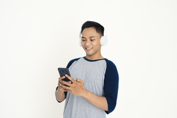 Young man with headphones listening to music on his phone.