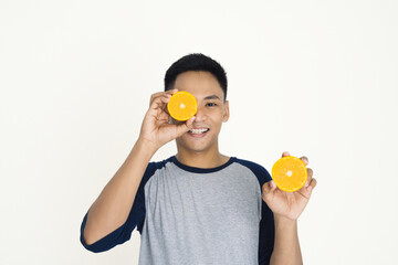 Smiling Man Holding Orange Halves with Joyful Expression on His Face