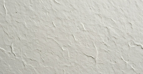 Obraz premium Subtle crack lines stretch across a clean white wall with fine granular texture. The minimalist detail adds a realistic depth to this neutral surface.