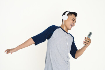 Young man with headphones listening to music on his phone.