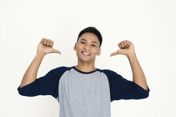 Young man in a gray shirt enthusiastically gesturing, showing excitement and joy on a white background.