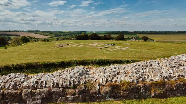 Concentric earthwork banks and weathered masonry remnants capturing the ancient fortifications, Old Sarum, Salisbury, Wiltshire, England, UK