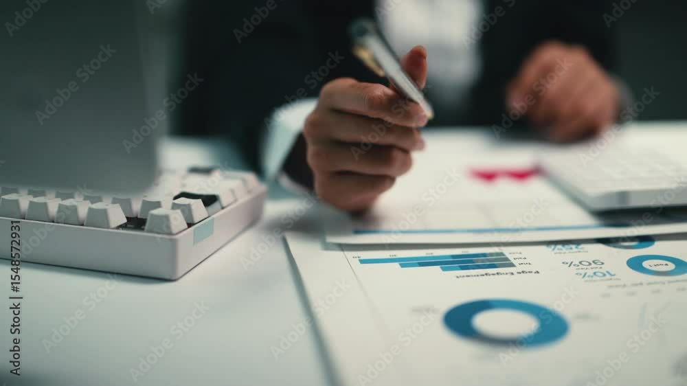 Aufkleber Professional businesswoman analyzing complex financial data, calculating expenses and growth metrics using calculator while taking detailed notes at office workspace