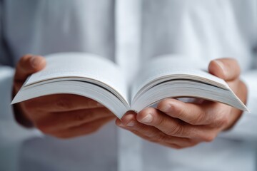 Closeup of hands holding open book