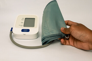 Digital blood pressure monitor device with hand, isolated on white background, equipment for health