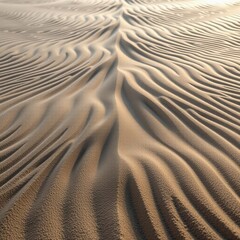 Fototapeta premium Close-up of intricate, wavy sand patterns formed by wind on a desert surface, showcasing texture and natural symmetry.