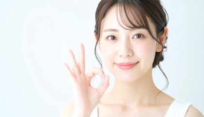 OKサインで微笑む女性 / 明るい笑顔とポジティブな気持ち / 清潔感あふれるOKポーズ