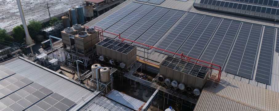 Cooling towers in data center building. Air conditioning cooling towers in front of building with fins to the front. Industrial cooling towers or air cooled water chillers with piping system.