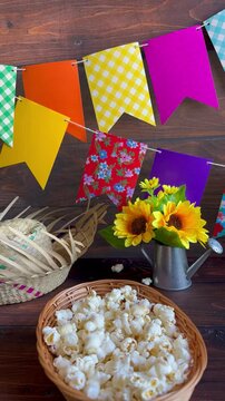 Colorful flags and popcorn on the table. Popcorn, a typical June festival food in Brazil.