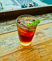 view of a glass of iced tea topped with mint leaves