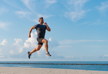 Sportsman running in summer. Sport runner training outdoor. Healthy lifestyle with daily run....