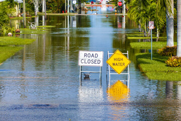Obraz na płótnie Canvas Hurricane Milton aftermath in Punta Gorda, Florida. City street closed because of flooding with warning signs blocking driving of cars