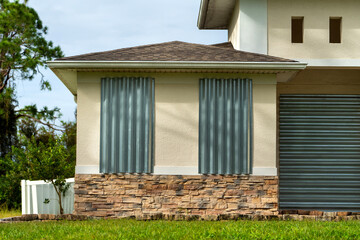 Residential house in Florida with reinforced storm shutters for hurricane protection. Window...