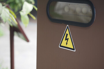Caution sign indicating electrical hazard at a park