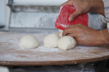 Preparing fresh dough in a bakery kitchen