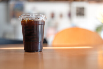 Cold brew black coffee with ice on wood table