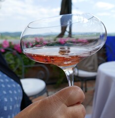 Refreshing wine beverage held in hand at outdoor winery patio