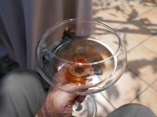 Point of view looking down into wineglass while swirling white wine around
