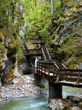 old wooden bridge above river in gorge