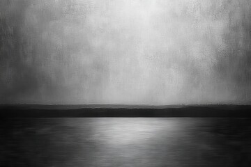 Gray landscape reflecting on still water.  