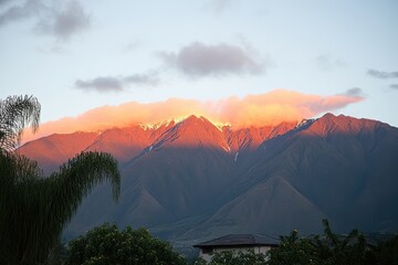 Majestic mountain range bathed in the warm hues of a vibrant sunrise