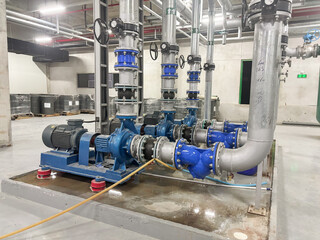 Large industrial pumps and insulated piping system in a modern chiller plant. Key components for...