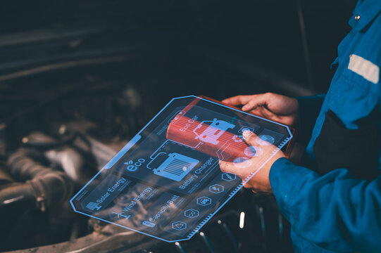 A technician uses augmented reality on a transparent tablet to analyze a car engine, displaying battery status and energy efficiency data. - Powered by Adobe