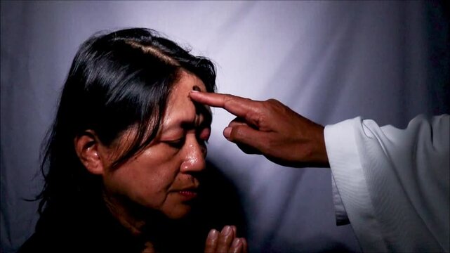 ash cross on woman forehead in ash wednesday celebration