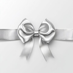 Elegant silver ribbon bow on white background, perfect for gift wrapping or festive decorations.