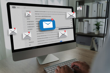 Obraz na płótnie Canvas man reading e-mail on smartphone email inbox and email with laptop on internet information from spam mail