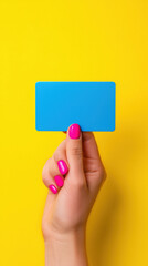 Hand holding blank blue unbranded card on vibrant yellow background