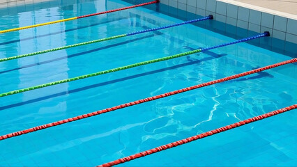 Obraz premium Top-Down Realistic View of Swimming Pool with Lane Dividers and Ripples