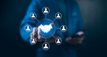 Businessman touches a handshake icon connected to a team network. Concept of Human Resource...