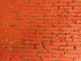 wall with exposed brick painted red