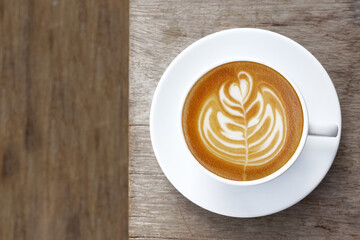  a cup of latte art coffee on wooden background                                                                                                                                                         